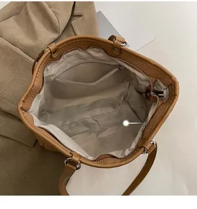 Top view of large tote bag showing spacious interior with zipper pocket and silver hardware