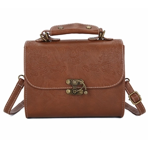 Retro brown embossed leather handbag with vintage floral patterns and adjustable strap
