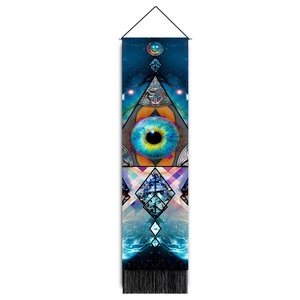 Macro detail of planet series tapestry showing blue eye symbol and black fringe