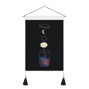 Detail of fabric wall hanging with daisy in nebula glass, moon, and black tassels