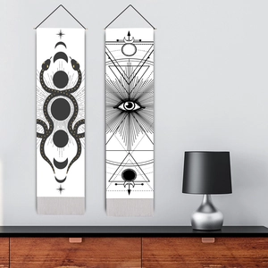 Modern black and white moon phase and eye wall tapestry with gold accents on grey wall
