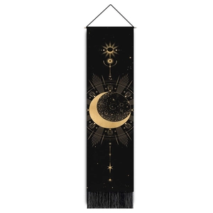 Detail of black sun and moon tapestry with golden celestial motifs and fringe