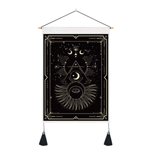 Detail of tarot tapestry with moon phases, sun and tassels on a wooden hanger