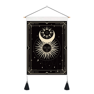 Detail of sun and moon astrology tapestry with black fabric and golden tassels