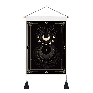 Detail of Nordic tarot tapestry with sun moon stars pattern and black tassels
