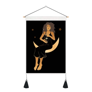 Detailed view of bohemian moon goddess tapestry with wooden scroll and black tassels