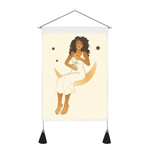 Detail of bohemian moon and girl wall tapestry with wooden rod and black tassels