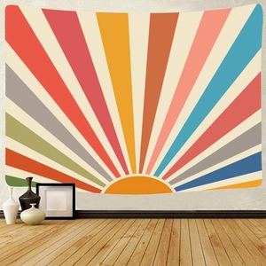 Close-up of retro hippie sunburst tapestry with colorful rays on a minimalist white wall