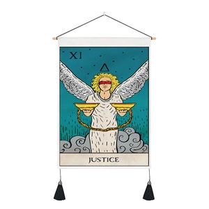 Close-up of Justice Tarot tapestry featuring black tassels and a wooden hanging rod