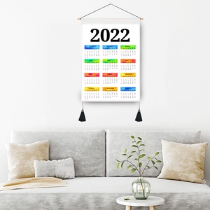 2022 colorful fabric wall calendar featuring a wooden hanging rod and black tassels