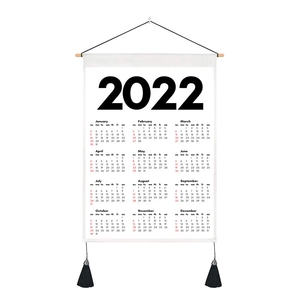 Detail of 2022 canvas wall calendar with wooden hanging rod and black tassels