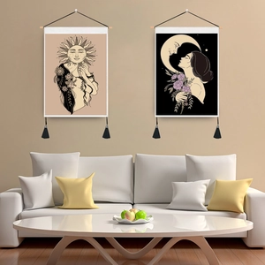 Detail of bohemian wall tapestry with wooden rod, black tassels and moon phase art