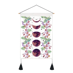 Bohemian moon phase tapestry with purple floral accents and decorative black tassels
