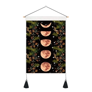 Bohemian moon phase tapestry with floral accents and black tassels for wall decor