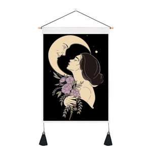Detail of bohemian moon goddess tapestry with wooden hanging rod and black tassels