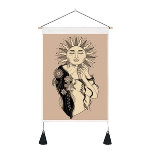 Detail of bohemian wall tapestry with lunar girl art, wood rod and black tassels