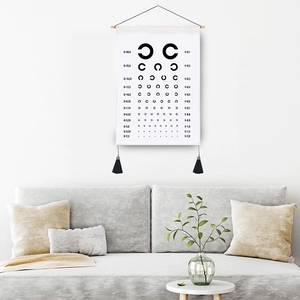 Minimalist Landolt C eye chart tapestry with wooden scroll and black tassels for wall decor