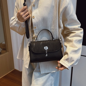 Vintage black PU leather messenger bag with silver lock and wide strap shown on model
