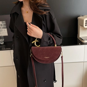 Chic burgundy semi-circle box bag with gold ring handle and leather shoulder strap