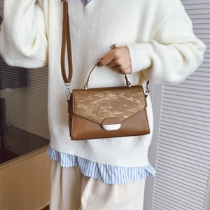Sac à main vintage marron avec rabat camouflage kaki et boucle dorée sur un mannequin