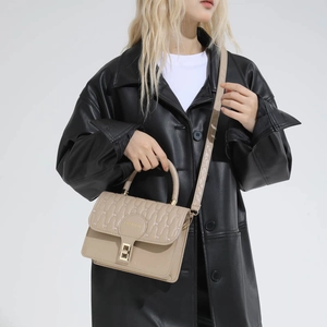 Beige quilted crossbody bag with golden twist-lock and leather shoulder strap for women