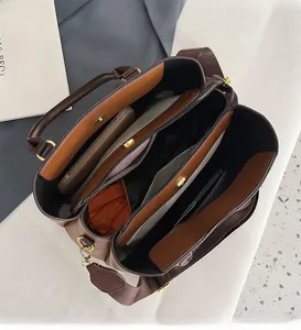 Top view showing the spacious interior and multiple compartments of a brown leather tote