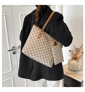 Rear view of model with large geometric tote bag and matching inner pouch set