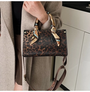 Detailed leopard print handbag with silk scarf handle and wide patterned shoulder strap