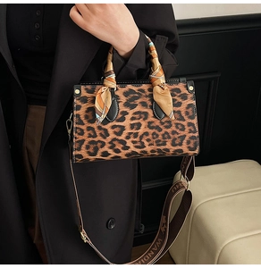 Detailed leopard print handbag with silk scarf handle and golden rivet accents
