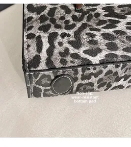 Close-up of leopard print bag bottom with non-slip studs and detailed stitching