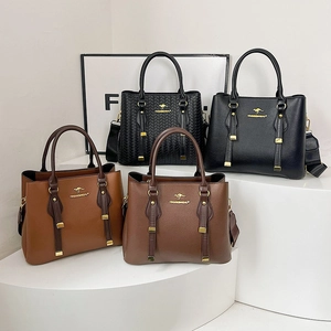 Set of stylish leather tote bags with gold logo in black and brown finishes