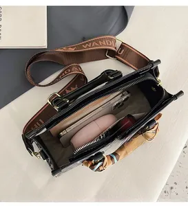 Interior view of black tote bag showing spacious storage for phone and cosmetics