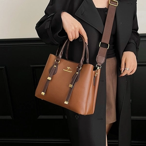 Brown leather tote bag with crossbody strap and gold logo detail for women