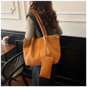 Detail of a large brown suede tote bag with a matching small pouch for commuting