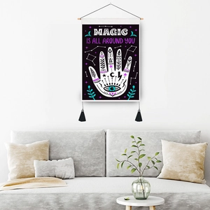 Bohemian black wall tapestry with Magic Is All Around You text and demonic hand art