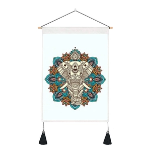 Detail of cotton linen wall hanging featuring elephant mandala and black tassels
