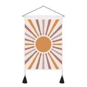 Bohemian sun tapestry with orange sunbeams, wooden rod and black tassels on white background