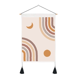 Bohemian tapestry featuring abstract sun and moon patterns with elegant black tassels