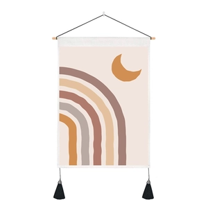 Detail of boho sun and moon wall tapestry with wooden rod and black tassels
