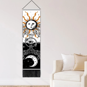 Vertical celestial tapestry with sun and moon motifs, black tassels, and occult symbols