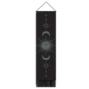 Detail of celestial tapestry featuring sun moon phases and stars with black fringe accents