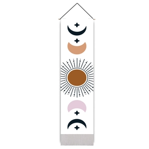 Detailed view of sun and moon wall tapestry with wood pole and grey tassels on bottom