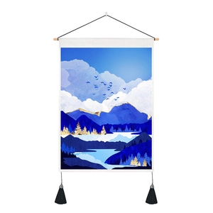 Detail of Nordic mountain tapestry with gemstone blue accents, wooden pole, and black tassels