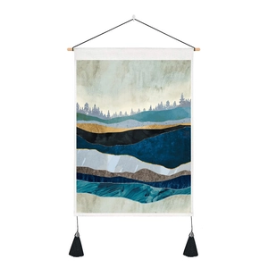 Detail of modern mountain tapestry with wooden pole, tassels, and abstract fabric texture