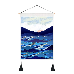 Close-up of modern abstract mountain tapestry with blue ocean waves and gold accents