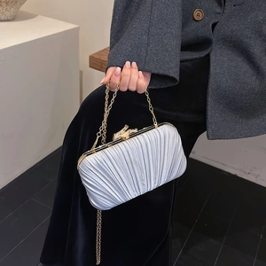 Pleated satin evening clutch with golden bow clasp and chain strap for women