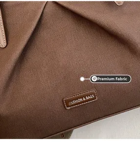 Macro detail of high-density brown fabric and premium leather logo tag on tote bag