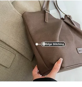 Close-up of brown tote bag featuring neat pressed edges and a gold FASHION nameplate