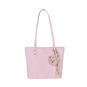 Pink PU leather tote bag with pleated texture and cute teddy bear pendant on white background