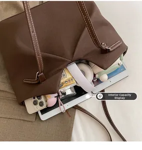 Interior view showing large capacity for tablet and phone in brown canvas tote